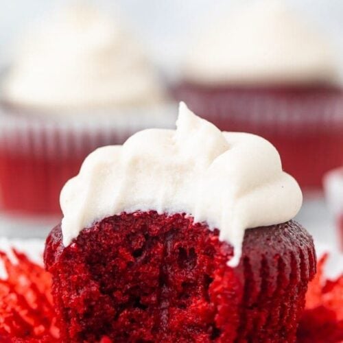 A vegan red velvet cupcake with a bite missing