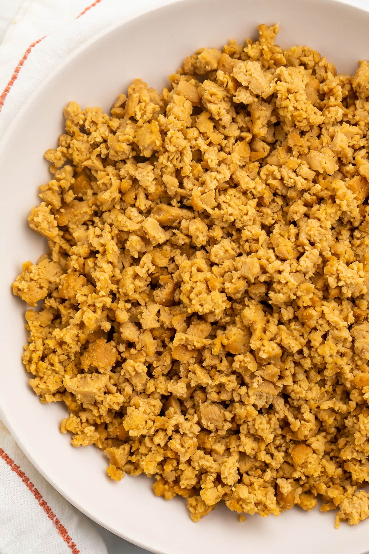 A bowl of crumbled ground beef made from seitan.