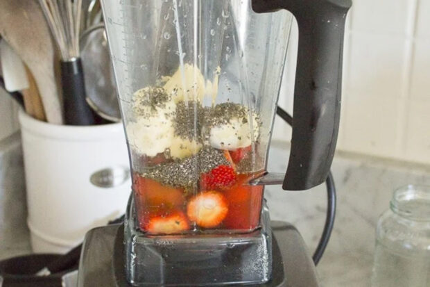 Flat tummy strawberry kombucha smoothie ingredients in a blender.