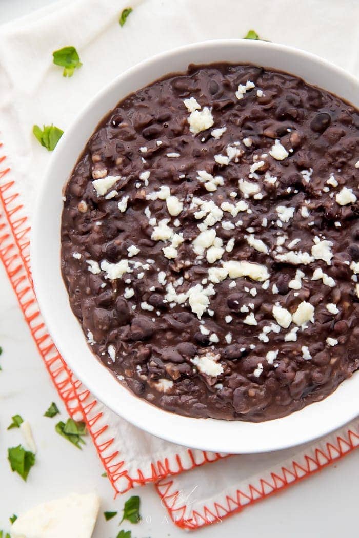 Bowl of refried black beans with queso fresco