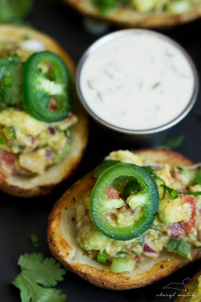 Vegan guacamole potato skins. Crispy potato skins topped with an incredibly flavorful, slightly smoky guacamole. Perfect for tailgating!