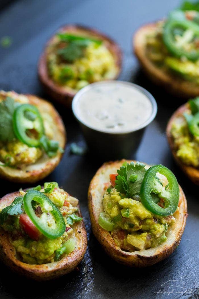 Vegan guacamole potato skins. Crispy potato skins topped with an incredibly flavorful, slightly smoky guacamole. Perfect for tailgating!