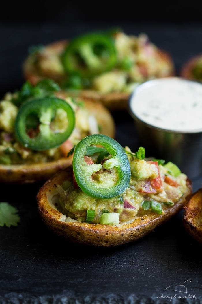 Vegan guacamole potato skins. Crispy potato skins topped with an incredibly flavorful, slightly smoky guacamole. Perfect for tailgating!