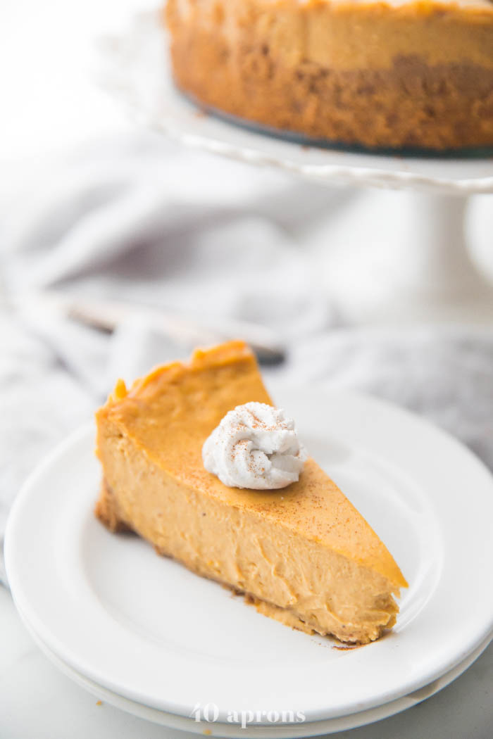 Vegan pumpkin cheesecake with whipped coconut cream on a plate