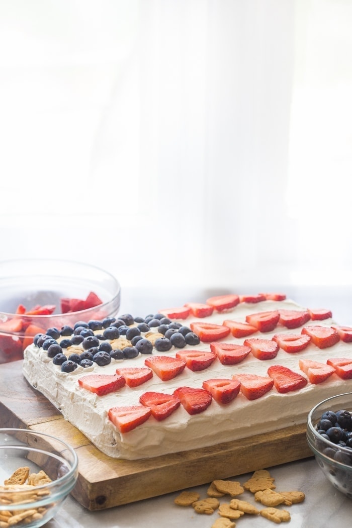 Flag Cake with Whipped Cream Frosting & Bunny Grahams // Rich yellow cake with a whipped cream-cream cheese frosting, finished with fresh fruit and sweet Bunny Grahams. Happy 4th of July, you beautiful patriot, you.