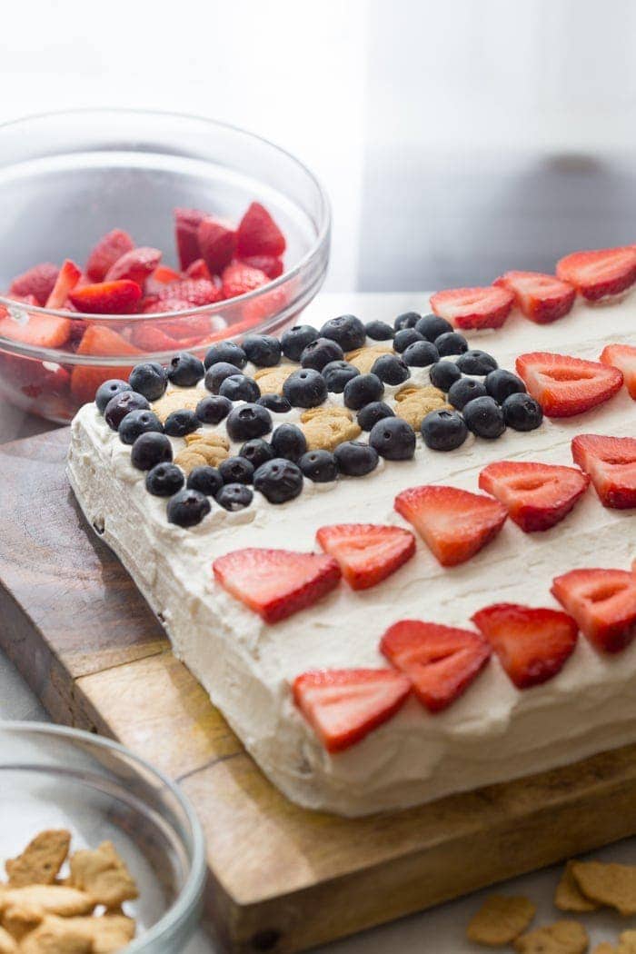 Flag Cake with Whipped Cream Frosting & Bunny Grahams // Rich yellow cake with a whipped cream-cream cheese frosting, finished with fresh fruit and sweet Bunny Grahams. Happy 4th of July, you beautiful patriot, you.