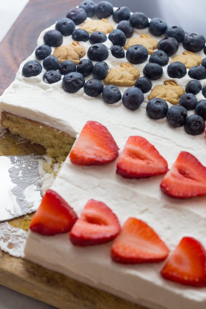 Flag Cake with Whipped Cream Frosting & Bunny Grahams // Rich yellow cake with a whipped cream-cream cheese frosting, finished with fresh fruit and sweet Bunny Grahams. Happy 4th of July, you beautiful patriot, you.