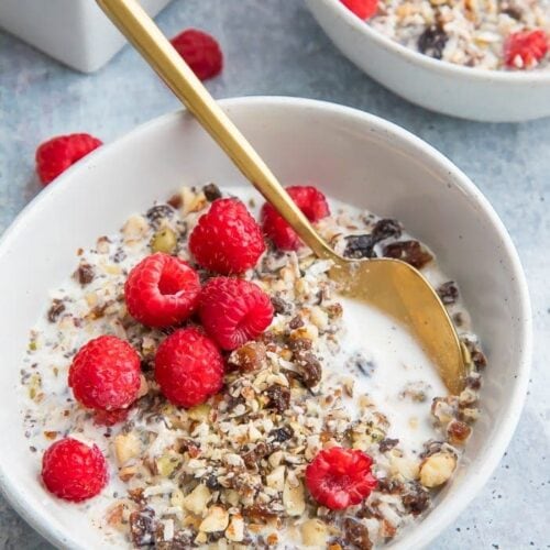 Two bowls of paleo cereal topped with raspberries