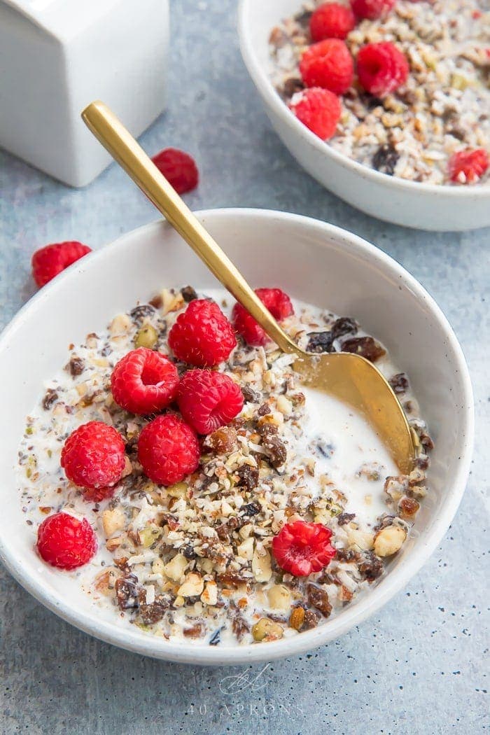 Two bowls of paleo cereal topped with raspberries