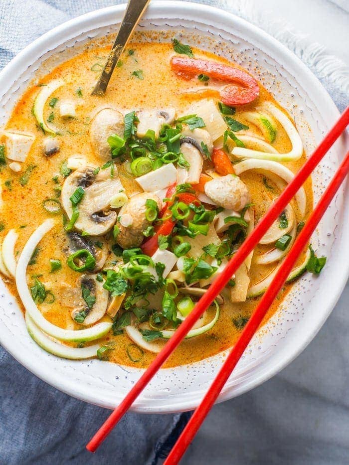 This paleo coconut curry zoodle soup is quick and delicious, loaded with creamy coconut milk, intensely flavorful red curry paste, and zoodles. This recipe is a wonderful paleo dinner or paleo soup recipe to add to your collection. Low carb yet filling, you can make this paleo coconut curry zoodle soup a vegan coconut curry zoodle soup with an easy swap!