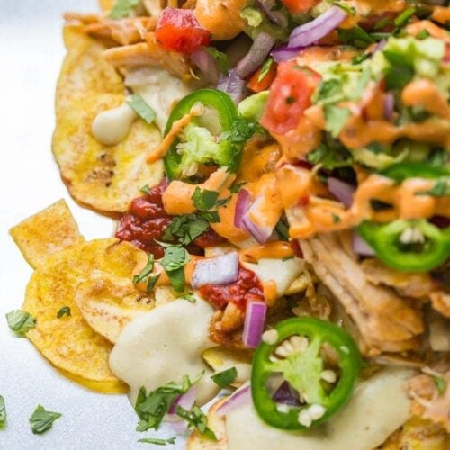 These paleo nachos are epic, aka the best paleo nachos ever. What makes paleo nachos epic, you ask? Well, what do you think of plantain chips topped with tender carnitas, the best paleo queso blanco, guacamole, pico de gallo, smoky guajillo salsa, and creamy chipotle sauce? If those doesn't sound like the best paleo nachos to you, I just don't even know who you are anymore.