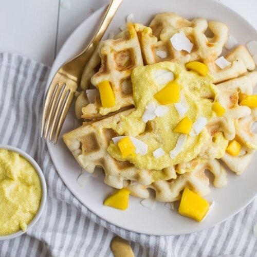 These paleo coconut waffles with sweet mango cream are tender and light, sweet and flavorful. Topped with a sweet mango cream made from healthy, real ingredients, this dish will become your favorite paleo breakfast recipe! And if you're asking me, this is the best paleo waffle recipe - the texture is light and fluffy, but you'll feel energized instead of sluggish after a stack. Perfect for spring and summer!