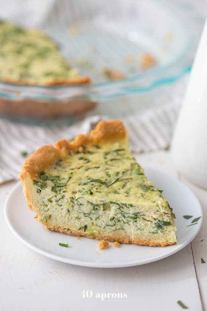 This paleo quiche with crab and spinach is a fantastic paleo Mother's Day brunch recipe, but it's versatile and quick enough to become a favorite paleo dinner or paleo brunch dish in your rotation. With an almond flour crust, this paleo quiche is so much like a cheesy, gluteny quiche!