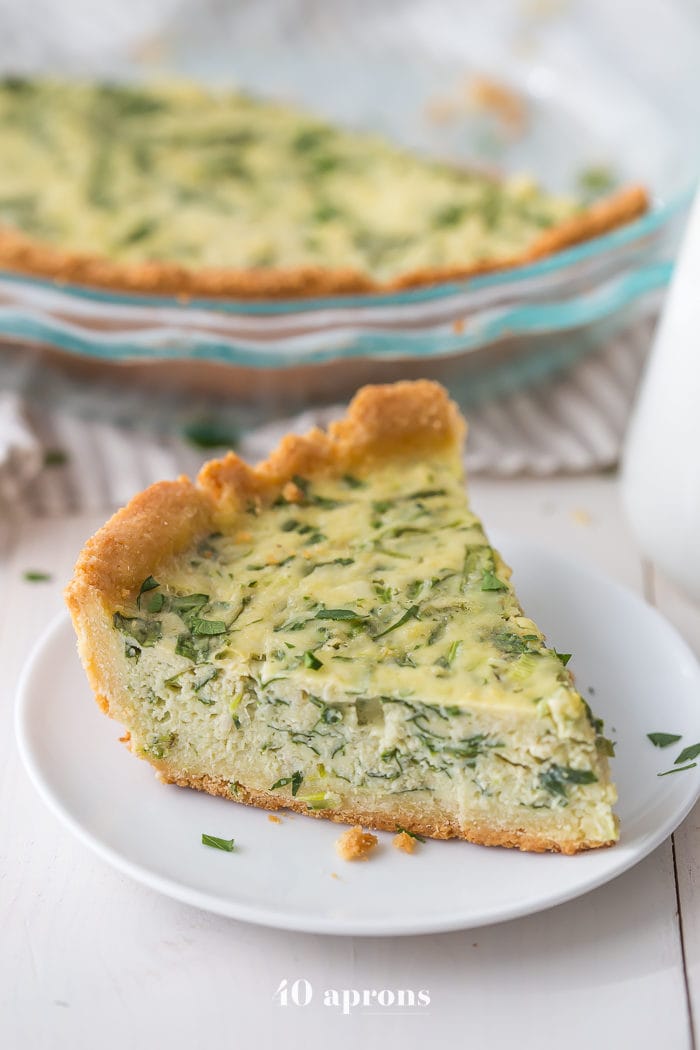 This paleo quiche with crab and spinach is a fantastic paleo Mother's Day brunch recipe, but it's versatile and quick enough to become a favorite paleo dinner or paleo brunch dish in your rotation. With an almond flour crust, this paleo quiche is so much like a cheesy, gluteny quiche!