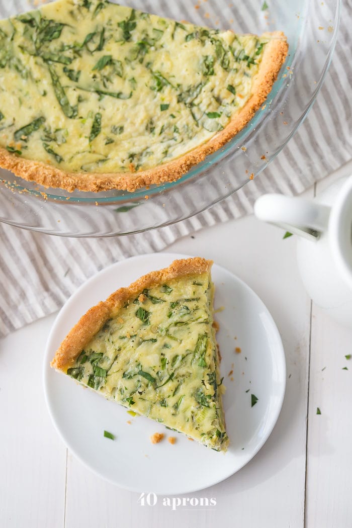 This paleo quiche with crab and spinach is a fantastic paleo Mother's Day brunch recipe, but it's versatile and quick enough to become a favorite paleo dinner or paleo brunch dish in your rotation. With an almond flour crust, this paleo quiche is so much like a cheesy, gluteny quiche!