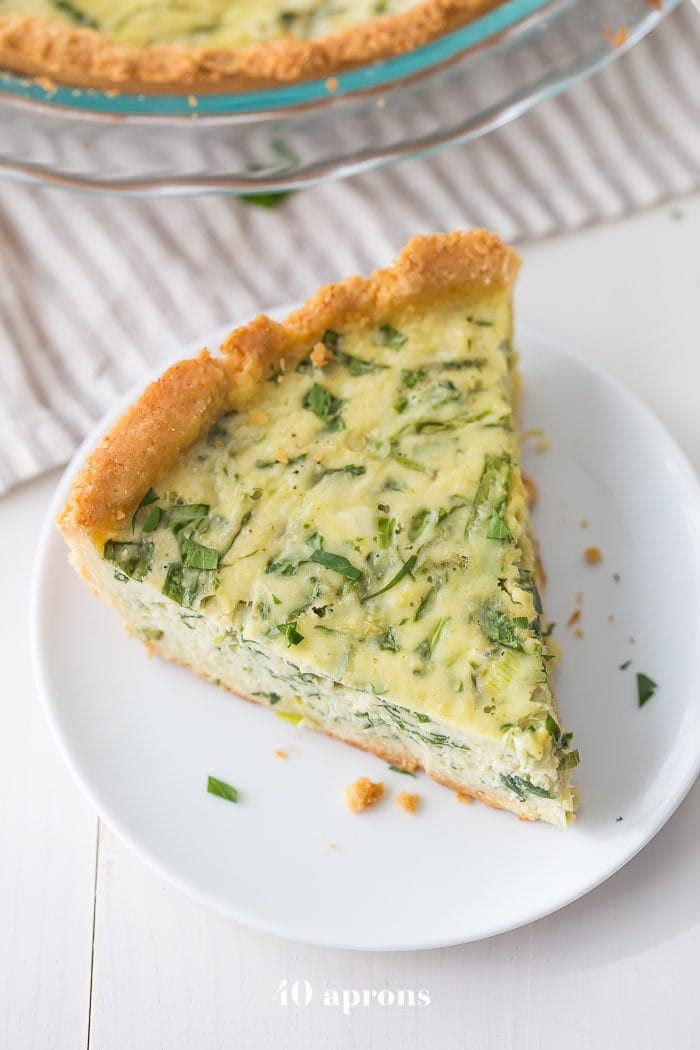 This paleo quiche with crab and spinach is a fantastic paleo Mother's Day brunch recipe, but it's versatile and quick enough to become a favorite paleo dinner or paleo brunch dish in your rotation. With an almond flour crust, this paleo quiche is so much like a cheesy, gluteny quiche!