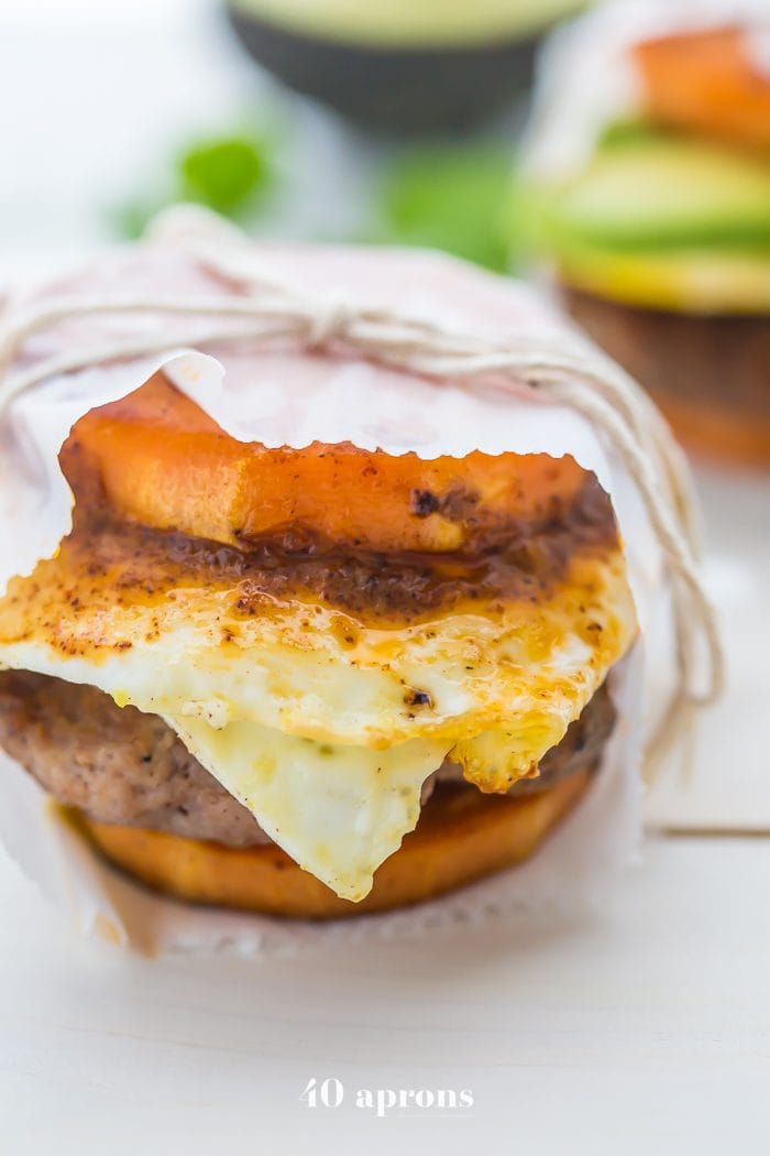 These Whole30 breakfast sandwiches are easy to make and insanely good. Buttery sweet potato buns layered with Whole30 breakfast sausage, fried egg, and avocado or quick Whole30 chipotle aioli, they're about to be your favorite Whole30 breakfast.