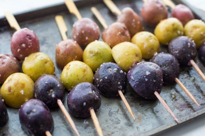 One of the best red, white, and blue side dishes! These grilled red, white, and blue potato skewers with ranch dressing are the perfect patriotic side dish. Garlicky, packed with flavor, and festive yet elegant, they go so well with burgers or brauts on the grill! One of the best red, white, and blue side dishes, these Whole30 potato skewers with ranch dressing are just delicious.