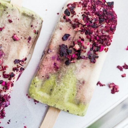 These mermaid popsicles layer a creamy coconut matcha mixture with a sweet coconut cream and honey roasted blackberries. Perfect for a mermaid party or mermaid birthday party, these stunning paleo popsicles are surprisingly easy. One of my favorite paleo popsicle recipes or vegan popsicle recipes, these mermaid popsicles are just too much fun! Made with the best popsicle mold and my favorite matcha powder.