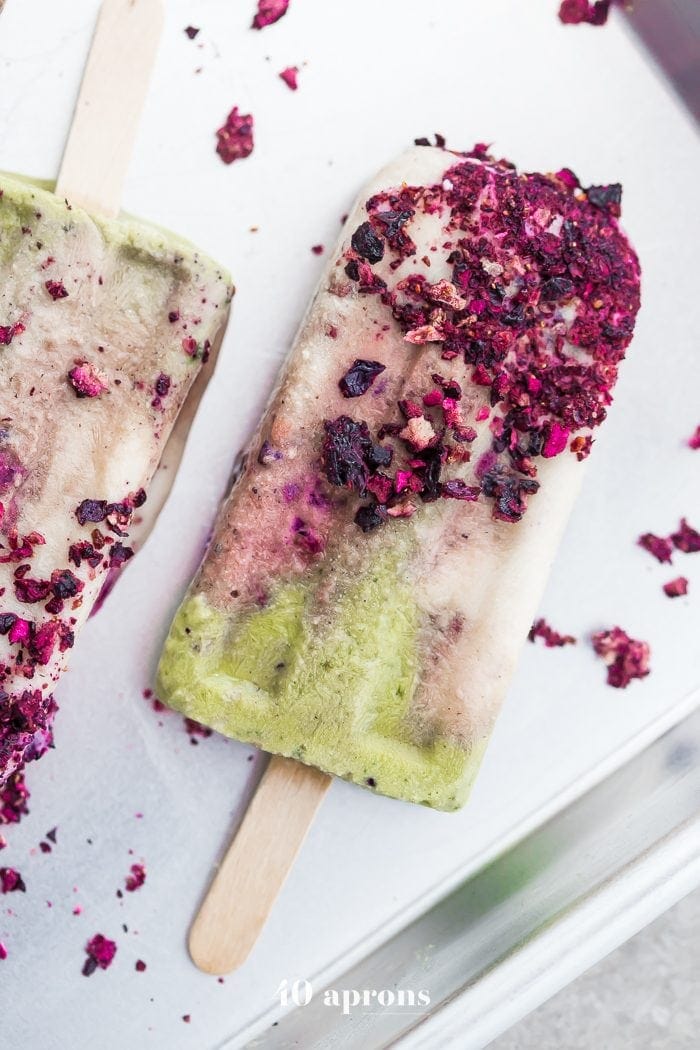 These mermaid popsicles layer a creamy coconut matcha mixture with a sweet coconut cream and honey roasted blackberries. Perfect for a mermaid party or mermaid birthday party, these stunning paleo popsicles are surprisingly easy. One of my favorite paleo popsicle recipes or vegan popsicle recipes, these mermaid popsicles are just too much fun! Made with the best popsicle mold and my favorite matcha powder.