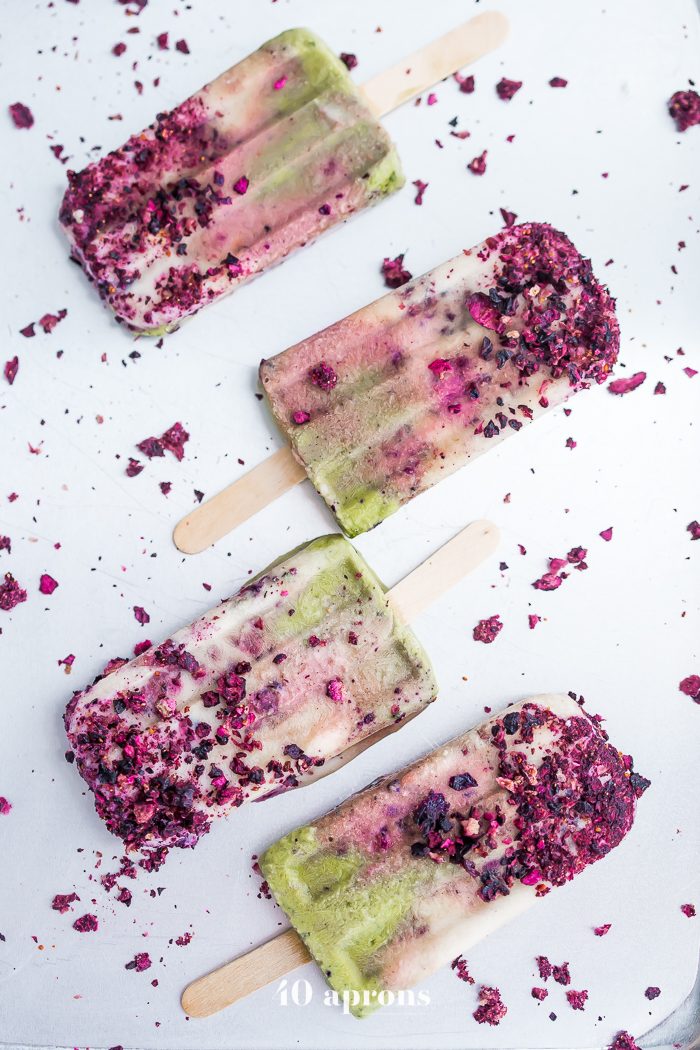 These mermaid popsicles layer a creamy coconut matcha mixture with a sweet coconut cream and honey roasted blackberries. Perfect for a mermaid party or mermaid birthday party, these stunning paleo popsicles are surprisingly easy. One of my favorite paleo popsicle recipes or vegan popsicle recipes, these mermaid popsicles are just too much fun! Made with the best popsicle mold and my favorite matcha powder.