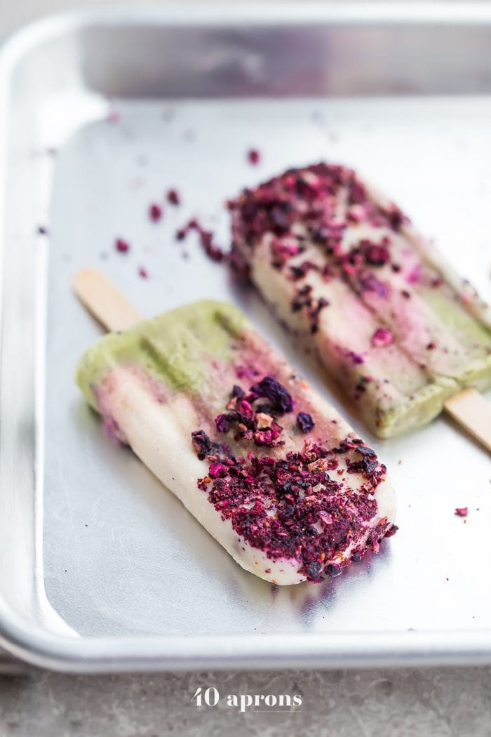 These mermaid popsicles layer a creamy coconut matcha mixture with a sweet coconut cream and honey roasted blackberries. Perfect for a mermaid party or mermaid birthday party, these stunning paleo popsicles are surprisingly easy. One of my favorite paleo popsicle recipes or vegan popsicle recipes, these mermaid popsicles are just too much fun! Made with the best popsicle mold and my favorite matcha powder.