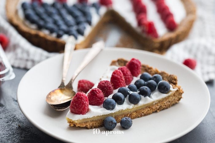 This paleo flag fruit tart is Fourth of July dessert perfection. With a coconut oil shortbread crust, rich almond frangiapane filling, and topped with cool coconut cream and fresh fruit, you've got your paleo Fourth of July dessert covered. Why make a paleo 4th of July cake when you can make a tart delicious enough to beat all other paleo 4th of July desserts?! U-S-A! U-S-A!