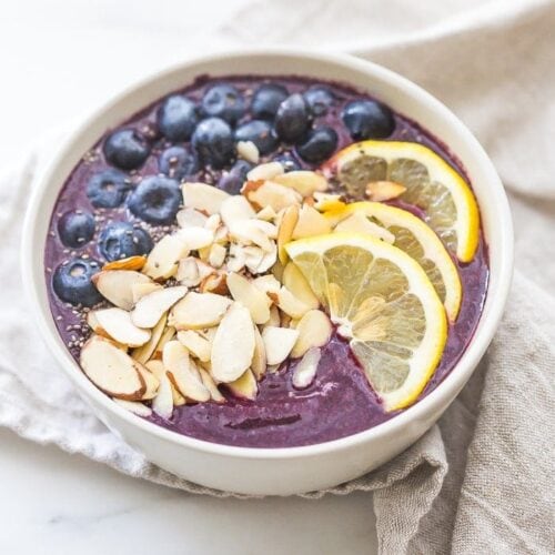 This blueberry muffin smoothie bowl is sweet with a touch of lemon and vanilla, just like a blueberry muffin! This blueberry smoothie bowl takes only 5 minutes and is paleo and vegan. With only 5 ingredients, you'll get addicted to this blueberry muffin smoothie bowl!