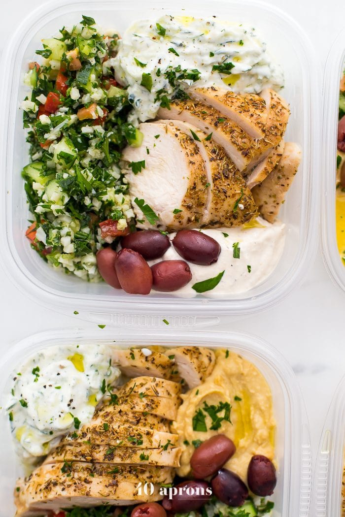 This Greek healthy meal prep recipe is epic: cauliflower rice tabbouleh, tender seasoned chicken breasts, hummus or baba ganoush, kalamata olives, and a rich, garlicky tzatziki. This healthy meal prep recipe will have you looking forward to lunch all morning! It's also a Whole30 meal prep recipe and paleo meal prep recipe, too, when you sub coconut cream or coconut yogurt for the yogurt. This is seriously SUCH a perfect healthy meal prep recipe.