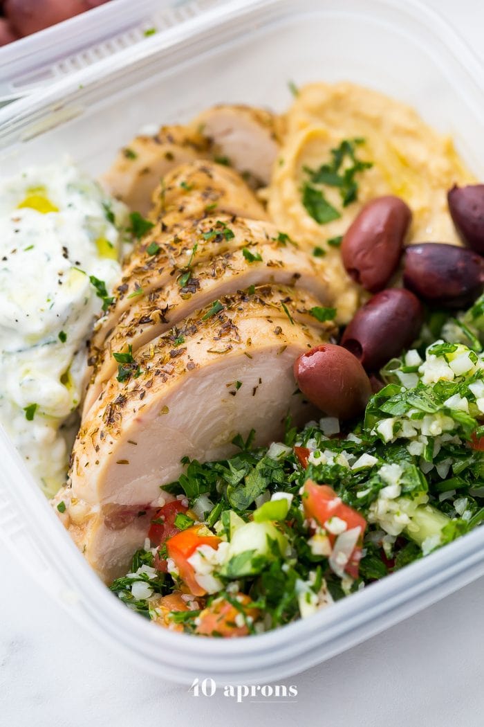 This Greek healthy meal prep recipe is epic: cauliflower rice tabbouleh, tender seasoned chicken breasts, hummus or baba ganoush, kalamata olives, and a rich, garlicky tzatziki. This healthy meal prep recipe will have you looking forward to lunch all morning! It's also a Whole30 meal prep recipe and paleo meal prep recipe, too, when you sub coconut cream or coconut yogurt for the yogurt. This is seriously SUCH a perfect healthy meal prep recipe.