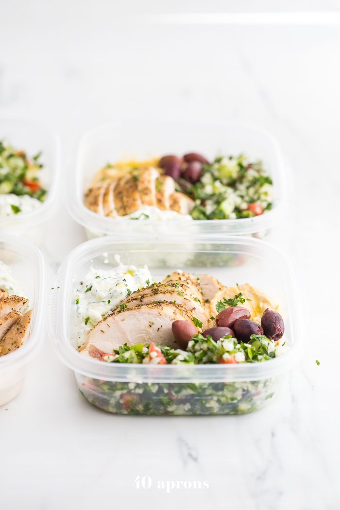 This Greek healthy meal prep recipe is epic: cauliflower rice tabbouleh, tender seasoned chicken breasts, hummus or baba ganoush, kalamata olives, and a rich, garlicky tzatziki. This healthy meal prep recipe will have you looking forward to lunch all morning! It's also a Whole30 meal prep recipe and paleo meal prep recipe, too, when you sub coconut cream or coconut yogurt for the yogurt. This is seriously SUCH a perfect healthy meal prep recipe.