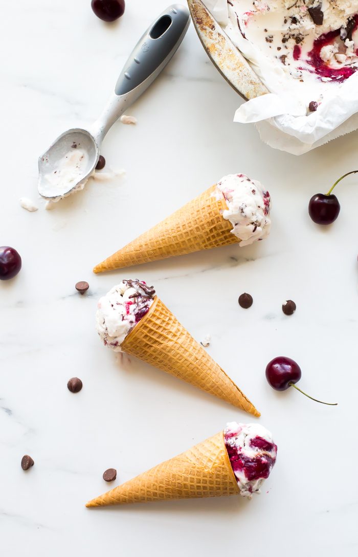 This paleo chocolate chip ice cream with roasted cherries is easy, rich, a bit tart, and totally delicious. With a vegan chocolate chip ice cream base, inspired by Italian stracciatella, it layers heady, roasted cherries, producing the perfect creamy, tart, chocolatey combination. Such a fantastic paleo ice cream recipe (or vegan ice cream recipe, if you prefer!). You absolutely must try this paleo chocolate chip ice cream with roasted cherries while the fruit is still in season.