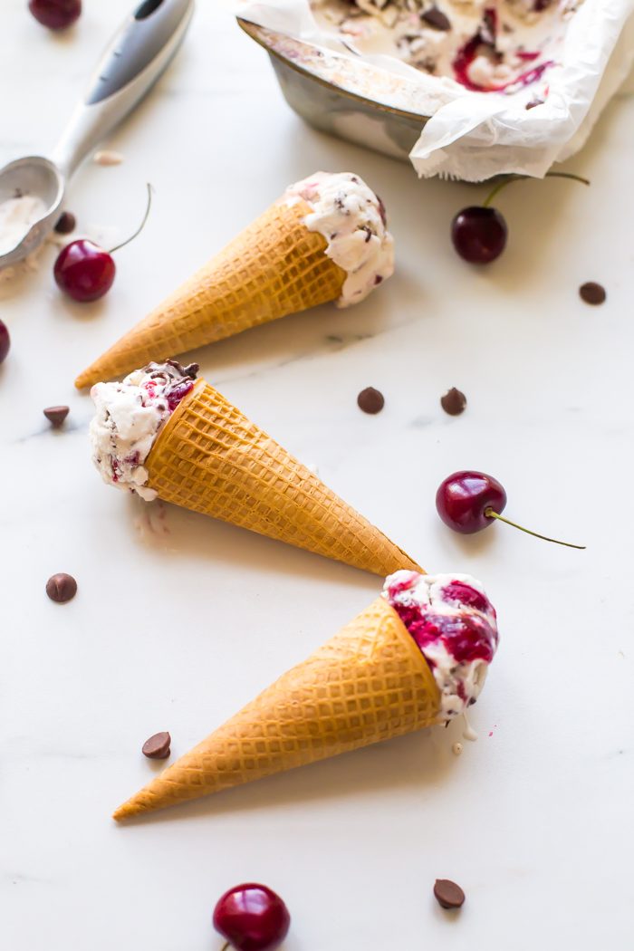 This paleo chocolate chip ice cream with roasted cherries is easy, rich, a bit tart, and totally delicious. With a vegan chocolate chip ice cream base, inspired by Italian stracciatella, it layers heady, roasted cherries, producing the perfect creamy, tart, chocolatey combination. Such a fantastic paleo ice cream recipe (or vegan ice cream recipe, if you prefer!). You absolutely must try this paleo chocolate chip ice cream with roasted cherries while the fruit is still in season.