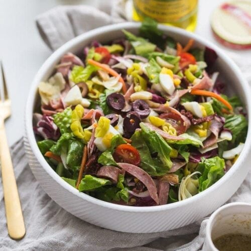 This paleo Italian salad is one of my very favorite paleo salads: loaded with radicchio, roasted garlic, olives, bright and spicy peperoncinis, salami, sun-dried tomatoes, and more. Such a great paleo dinner, paleo salad, or paleo side dish! Seriously, this paleo Italian salad will become a staple in your meal plan.