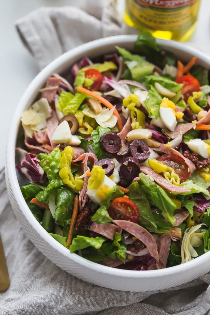 This paleo Italian salad is one of my very favorite paleo salads: loaded with radicchio, roasted garlic, olives, bright and spicy peperoncinis, salami, sun-dried tomatoes, and more. Such a great paleo dinner, paleo salad, or paleo side dish! Seriously, this paleo Italian salad will become a staple in your meal plan.