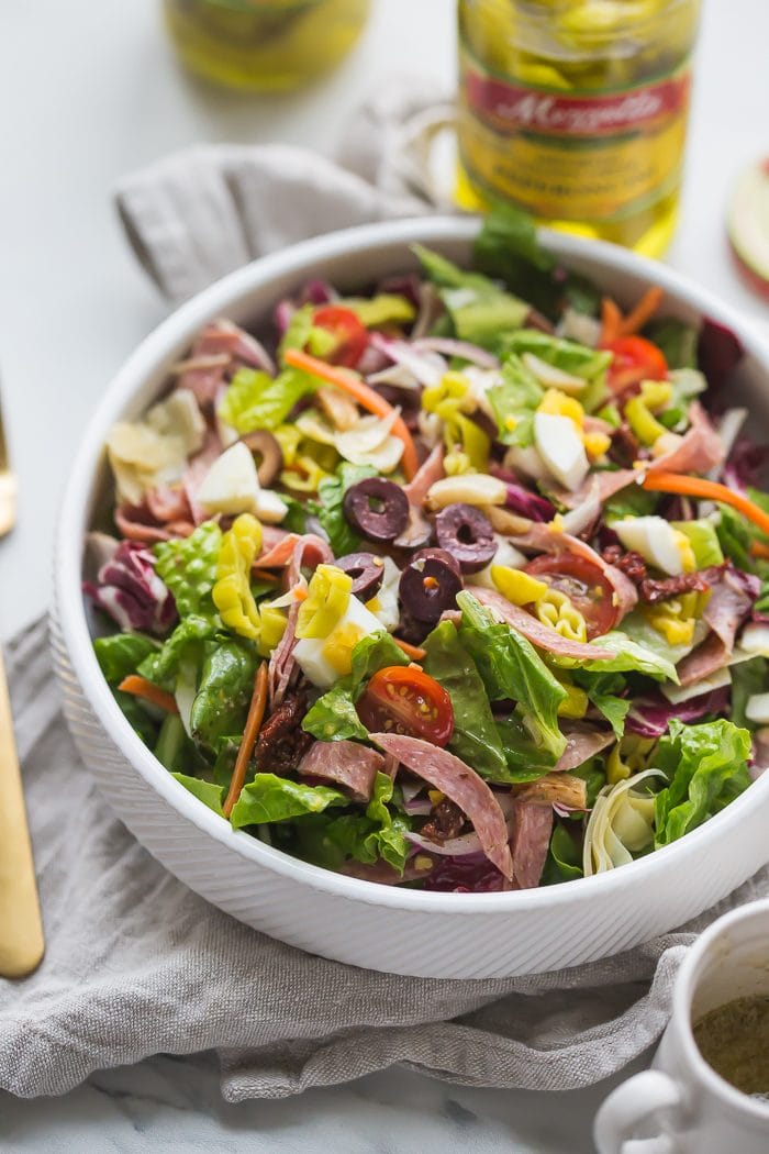 This paleo Italian salad is one of my very favorite paleo salads: loaded with radicchio, roasted garlic, olives, bright and spicy peperoncinis, salami, sun-dried tomatoes, and more. Such a great paleo dinner, paleo salad, or paleo side dish! Seriously, this paleo Italian salad will become a staple in your meal plan.