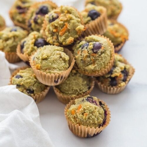 These gluten-free muffins for kids (with blueberries and avocado) are the perfect back-to-school muffins! Gluten and grain free, made with cultured dairy, and with low sugar, they're great to serve to a class, too. These gluten-free muffins for kids are packed with fruits and veggies, including carrots, avocado, and blueberries! I think your family will love these gluten-free muffins for kids just as much as mine does.