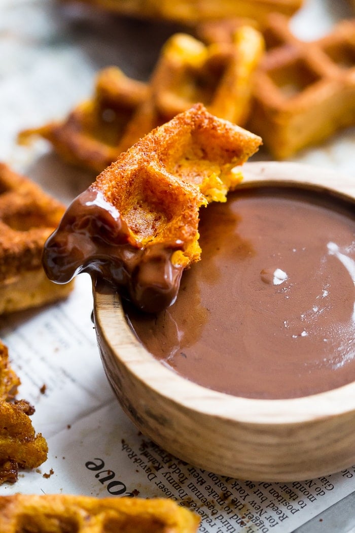 These paleo pumpkin churros with dark chocolate sauce are heavenly: loaded with fall flavor, crispy on the outside, tender on the inside, and made in the waffle iron! They're such a perfect paleo fall recipe because they're totally delicious but there's no frying necessary. These paleo pumpkin churros with dark chocolate sauce are a must make when it comes to paleo fall recipes!