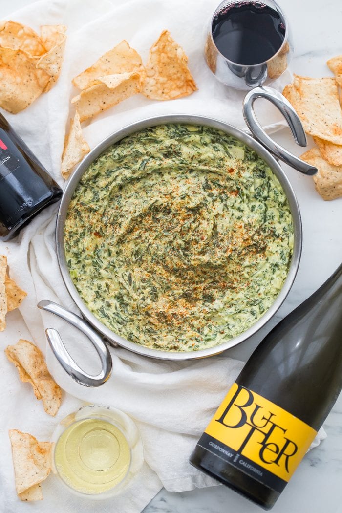 This paleo spinach artichoke dip is a healthy take on the classic appetizer. Rich and creamy, this vegan spinach artichoke dip is the perfect recipe for casual entertaining, especially in late summer and early fall. This paleo spinach artichoke dip is dairy free and goes perfectly with some paleo tortilla chips! One of my very favorite paleo appetizers, it really doesn't taste paleo!