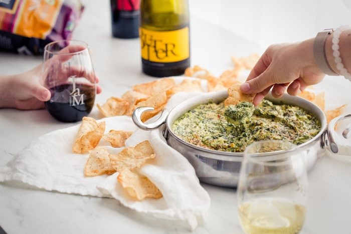 This paleo spinach artichoke dip is a healthy take on the classic appetizer. Rich and creamy, this vegan spinach artichoke dip is the perfect recipe for casual entertaining, especially in late summer and early fall. This paleo spinach artichoke dip is dairy free and goes perfectly with some paleo tortilla chips! One of my very favorite paleo appetizers, it really doesn't taste paleo!