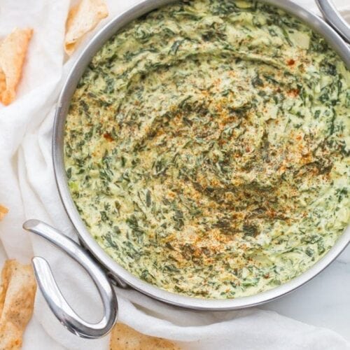 This paleo spinach artichoke dip is a healthy take on the classic appetizer. Rich and creamy, this vegan spinach artichoke dip is the perfect recipe for casual entertaining, especially in late summer and early fall. This paleo spinach artichoke dip is dairy free and goes perfectly with some paleo tortilla chips! One of my very favorite paleo appetizers, it really doesn't taste paleo!