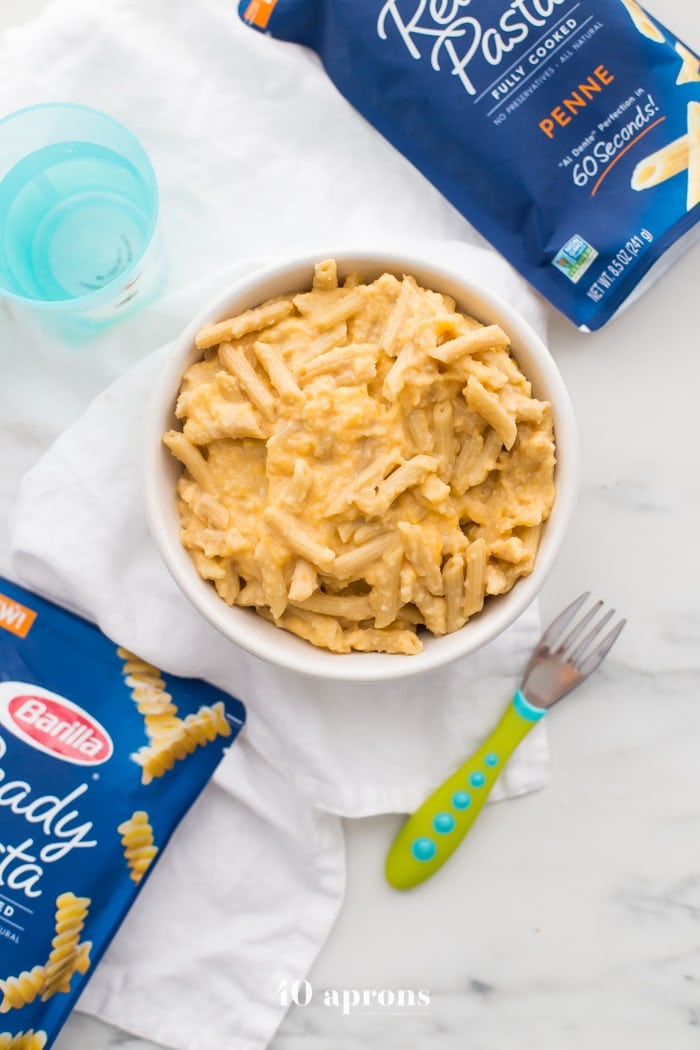 This quick hidden veggie mac and cheese comes together in only 5 minutes and gets its creaminess from veggies! The perfect toddler mac and cheese, this quick hidden veggie mac and cheese is healthier and way better than boxed! Made with frozen cauliflower rice and carrots, Barilla Ready Pasta, and a bit of cheddar cheese, this quick hidden veggie mac and cheese will become a staple in yours kids' diets.