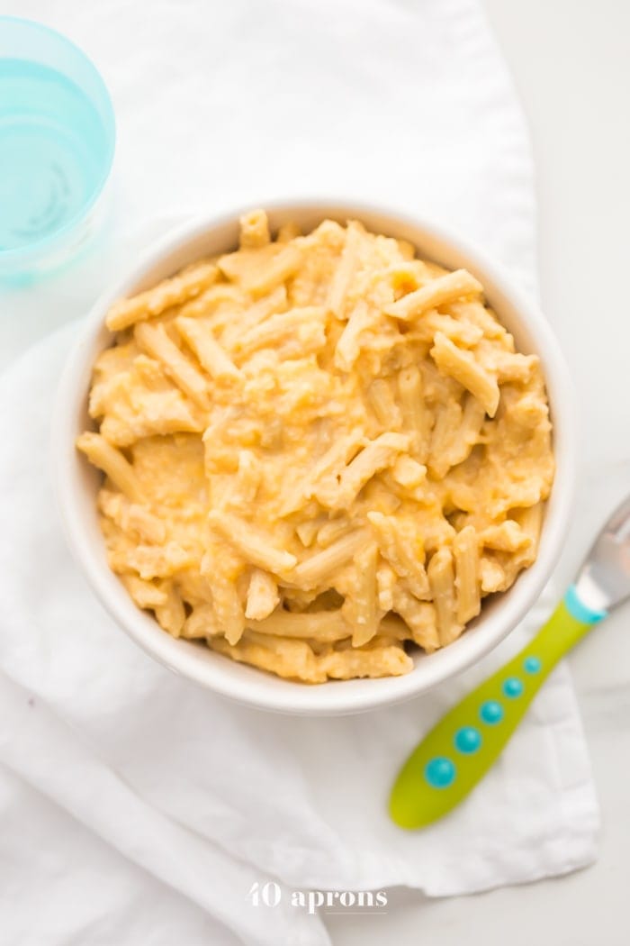 This quick hidden veggie mac and cheese comes together in only 5 minutes and gets its creaminess from veggies! The perfect toddler mac and cheese, this quick hidden veggie mac and cheese is healthier and way better than boxed! Made with frozen cauliflower rice and carrots, Barilla Ready Pasta, and a bit of cheddar cheese, this quick hidden veggie mac and cheese will become a staple in yours kids' diets.