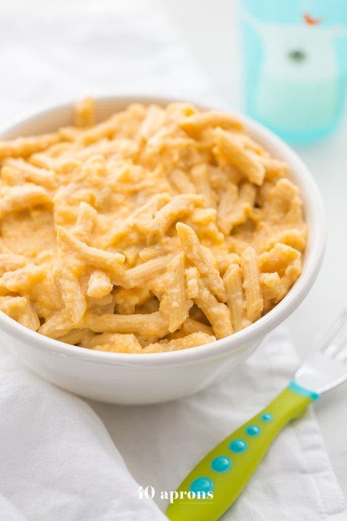 This quick hidden veggie mac and cheese comes together in only 5 minutes and gets its creaminess from veggies! The perfect toddler mac and cheese, this quick hidden veggie mac and cheese is healthier and way better than boxed! Made with frozen cauliflower rice and carrots, Barilla Ready Pasta, and a bit of cheddar cheese, this quick hidden veggie mac and cheese will become a staple in yours kids' diets.