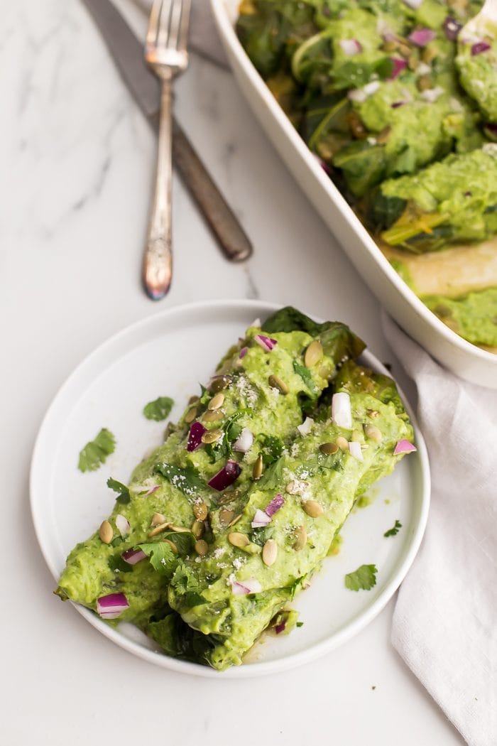 These Whole30 enchiladas are out of control! Stuffed with a roasted poblano pepper and ground pork mixture, seasoned with a, wait for it... cilantro-spinach-pepita pesto and plenty of mushrooms, they're the perfect Whole30 enchiladas recipe and they make a fantastic Whole30 dinner recipe. Topped with a rich, creamy avocado-cilantro sauce, you've got the best Whole30 enchiladas recipe ever... or maybe the best Whole30 dinner recipe ever? You decide. 