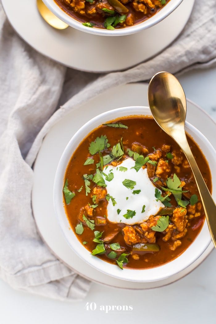 This chicken tikka masala chili is the stuff your dreams are made of. This Whole30 chili has a rich and creamy tomato sauce, with beautiful caramelized onions, garlic, and chiles, loaded with tender ground chicken and veggies. Inspired by my beloved chicken tikka masala recipe, this chicken tikka masala chili is a must make for fall! It'll surely become your favorite Whole30 chili, too.