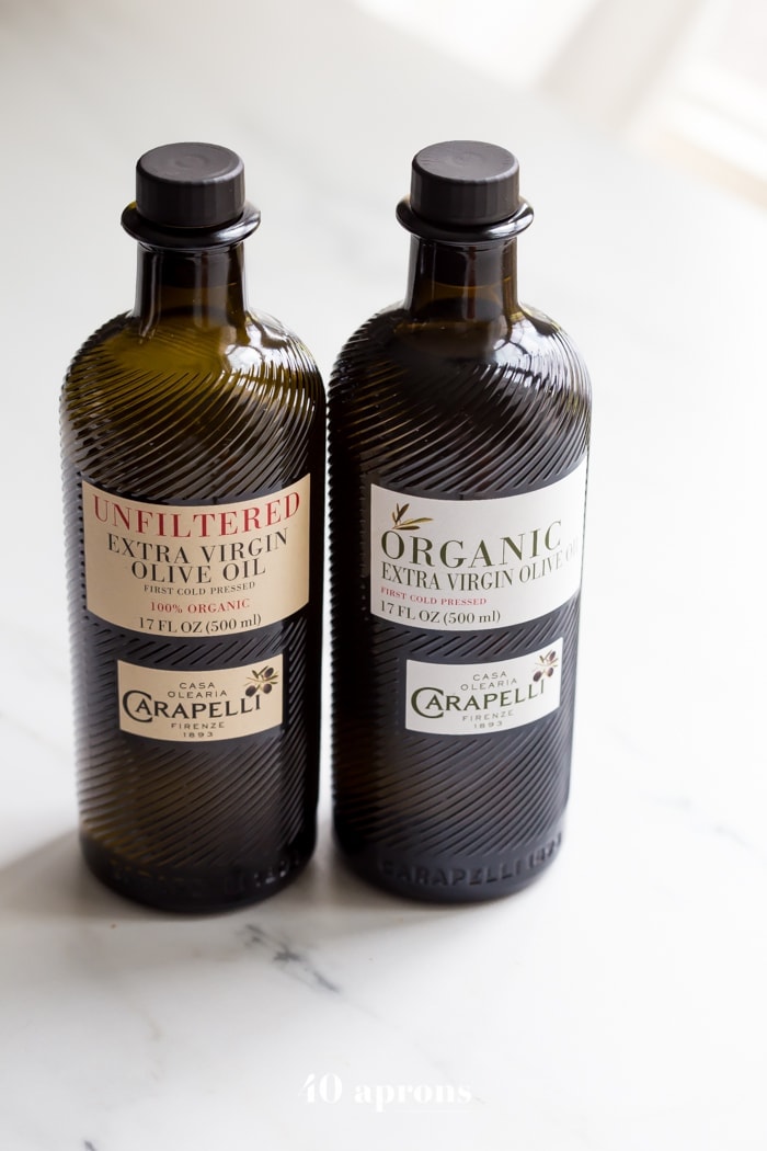 two bottles of Carapelli olive oil -one organic, one unfiltered