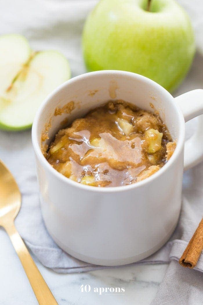 This paleo caramel apple microwave cake is inexplicably good, with a moist cinnamon-spiced cake, tender green apples, and a 2-minute caramel sauce to top it all. I bet you'll make this paleo caramel apple microwave cake all the time, since it only take a few minutes to stir together and two minutes in the microwave to cook! This paleo caramel apple microwave cake is the perfect paleo microwave dessert. I'm obsessed!