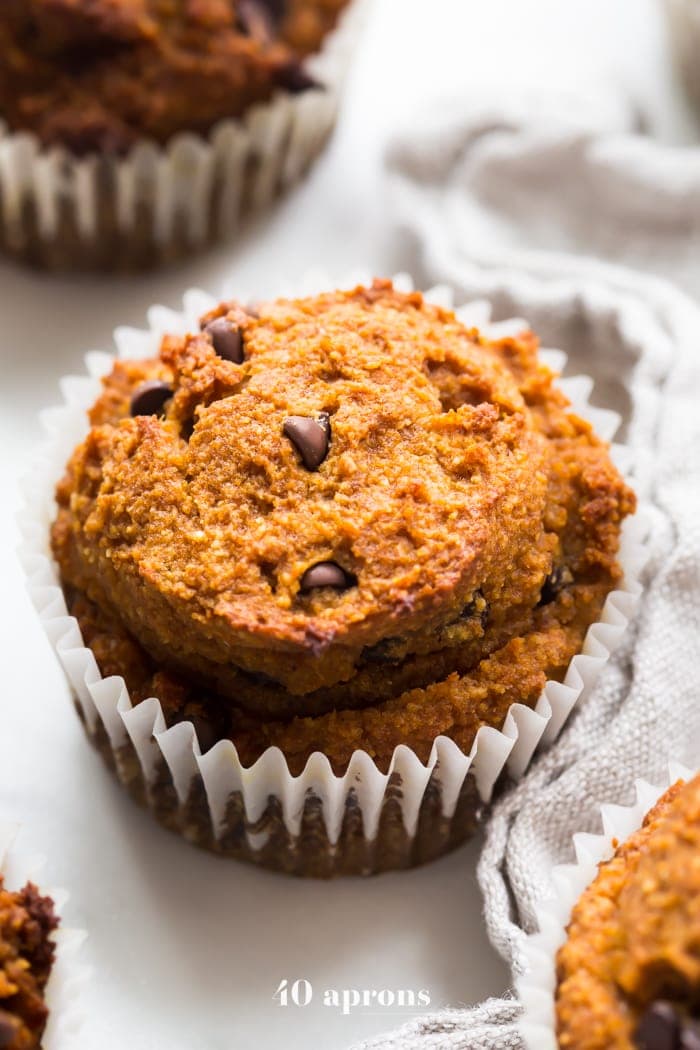 These paleo pumpkin chocolate chip muffins with cream cheese frosting are the perfect paleo fall recipe or paleo pumpkin recipe! They're moist and tender, loaded with pumpkin purée, dairy-free chocolate chips, and topped with a tangy but sweet frosting. And yep, they're entirely paleo. These paleo pumpkin chocolate chip muffins with cream cheese frosting are actually easy to make, too, so they'll become your very favorite paleo fall recipe or paleo pumpkin recipe for sure!