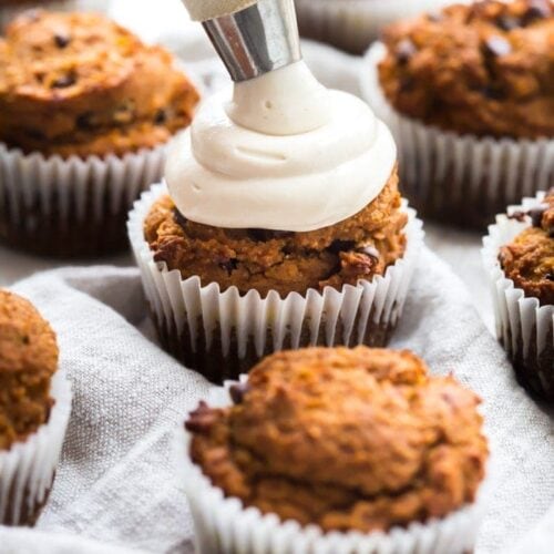 These paleo pumpkin chocolate chip muffins with cream cheese frosting are the perfect paleo fall recipe or paleo pumpkin recipe! They're moist and tender, loaded with pumpkin purée, dairy-free chocolate chips, and topped with a tangy but sweet frosting. And yep, they're entirely paleo. These paleo pumpkin chocolate chip muffins with cream cheese frosting are actually easy to make, too, so they'll become your very favorite paleo fall recipe or paleo pumpkin recipe for sure!